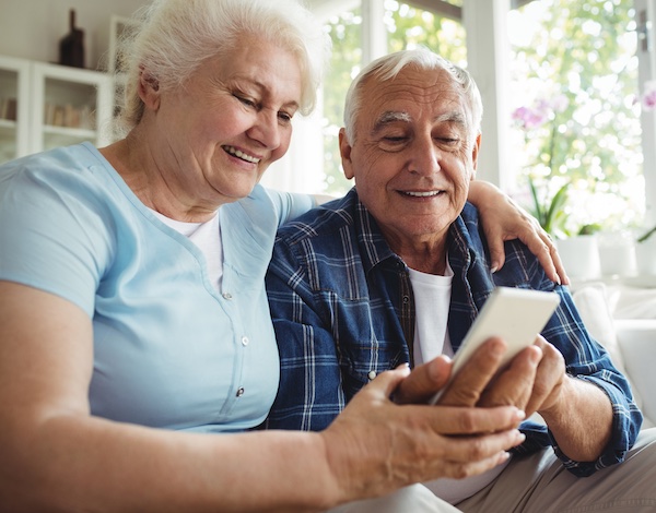 senior woman and man videochatting on a cellular phone